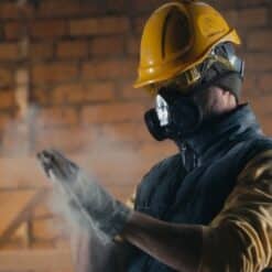 Male builder on site wearing a respirator