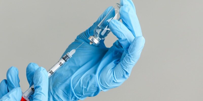 Medical professional filling a syringe