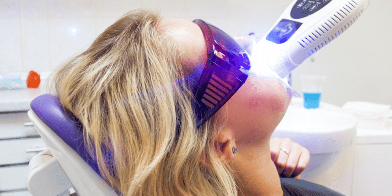 Women whitening teeth - Why Dentists Should Be Using LED Teeth Whitening Lights